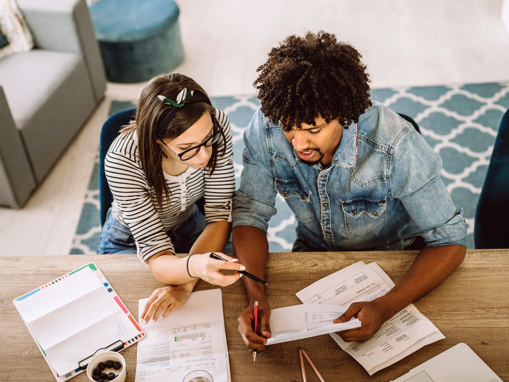 two people at a desk checking their credit score