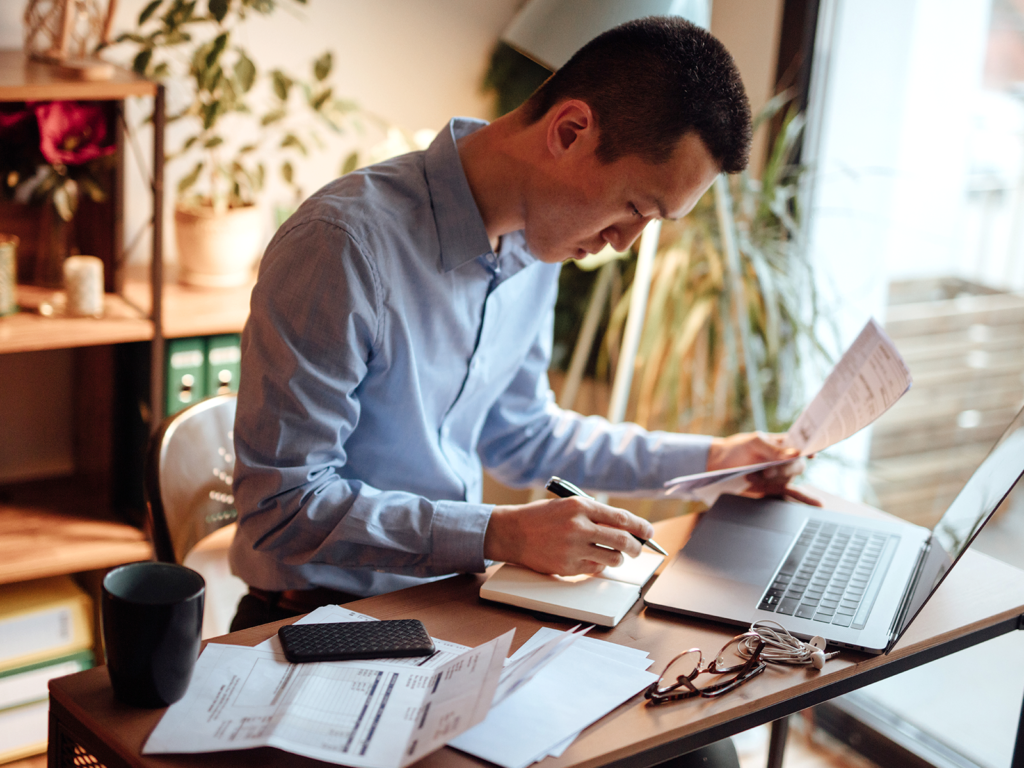 a man working at his desk on a laptop