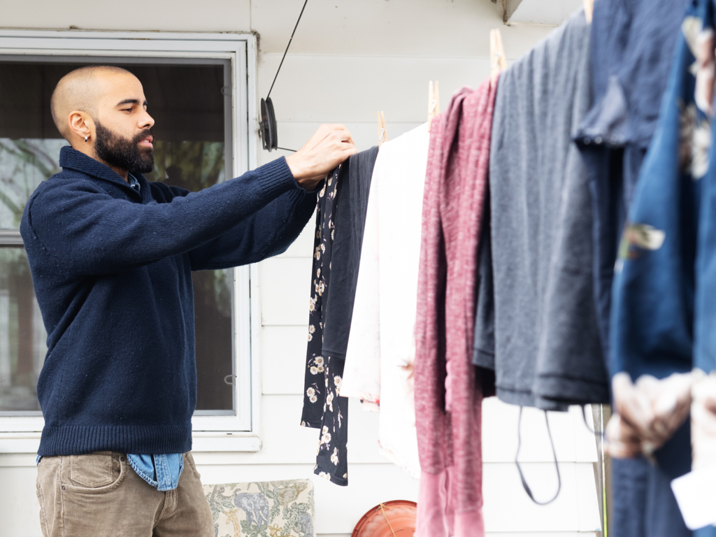 a person hanging their clothes to dry