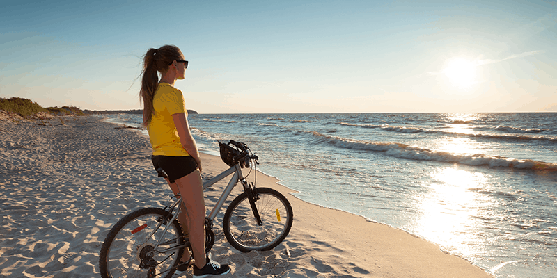 person on bike at grand beach