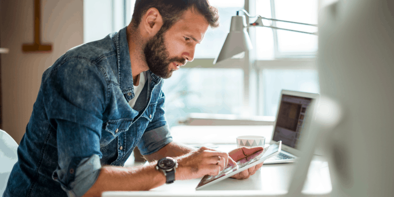 person on ipad at a desk